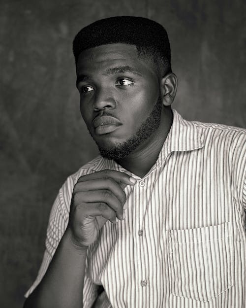 Grayscale Photo of a Man Wearing Striped Long Sleeves 