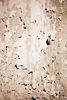 Close-up of a weathered wall with peeling paint texture in Bandung, Indonesia.