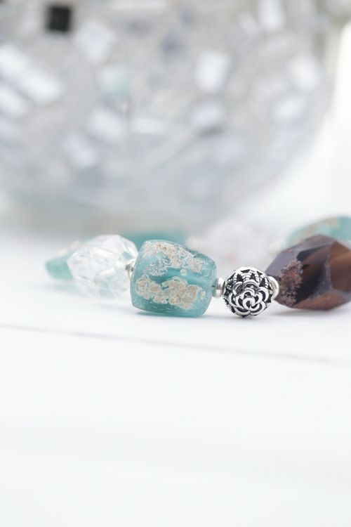 Free Intricate silver and gemstone beaded bracelet in a softly lit close-up still life. Stock Photo