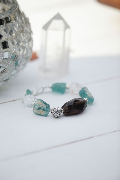 Free Elegant gemstone bracelet featuring unique stones, displayed on a light wooden surface, perfect for fashion enthusiasts. Stock Photo