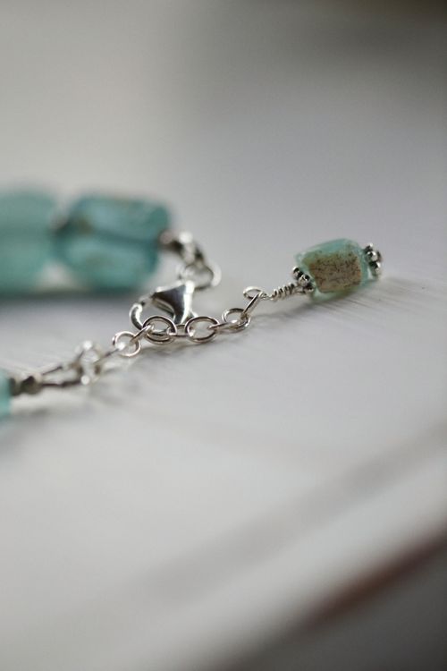 Free Close-up view of a turquoise gemstone bracelet with a delicate clasp. Stock Photo