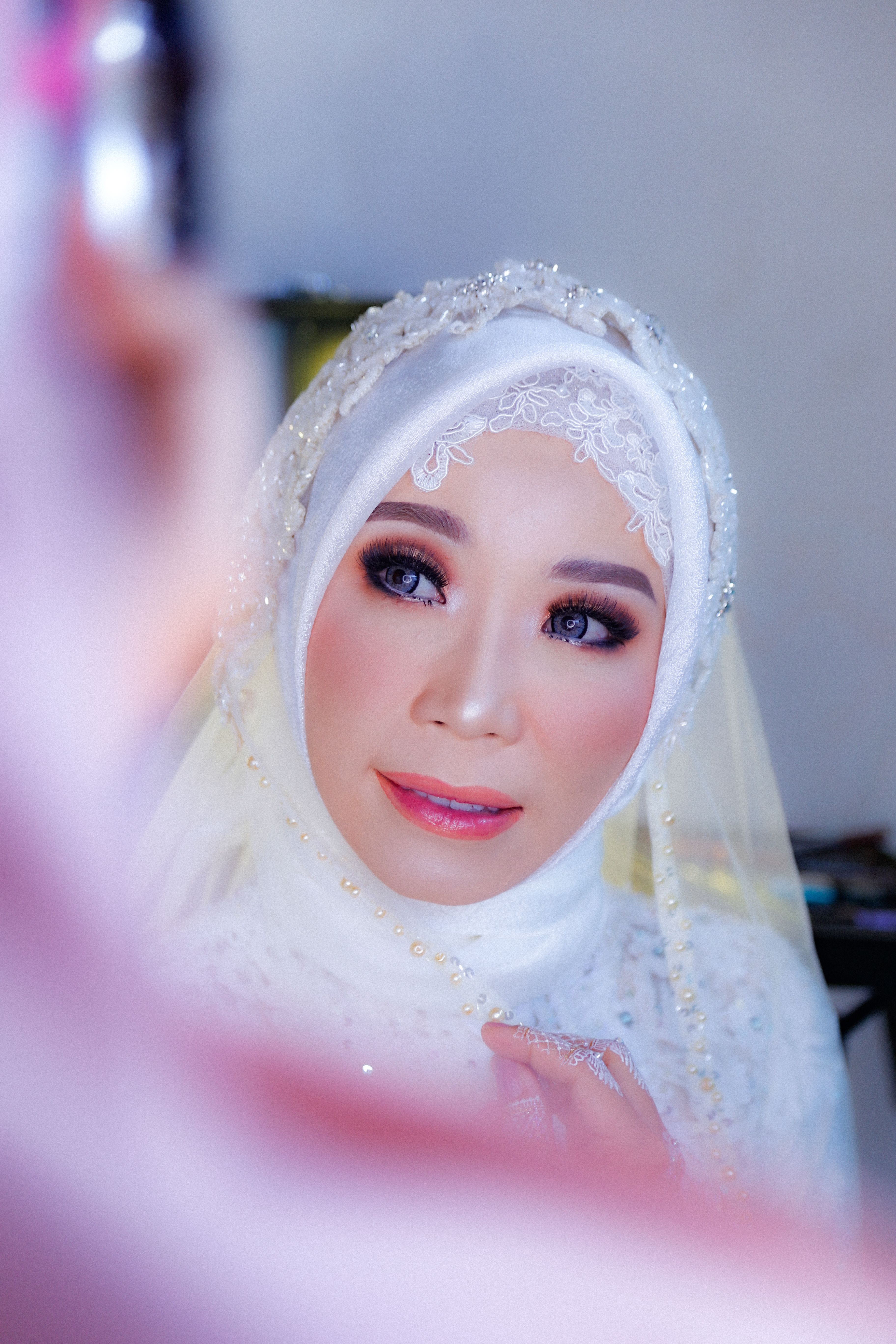 Hijabi bride in white with soft glam makeup