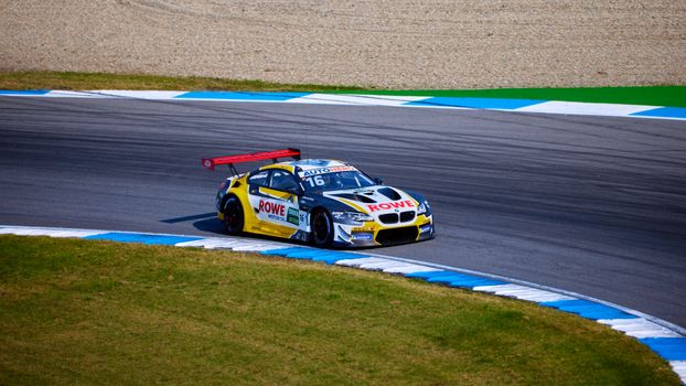 Dynamic shot of a race car speeding on Hockenheim track during a thrilling motorsport event.