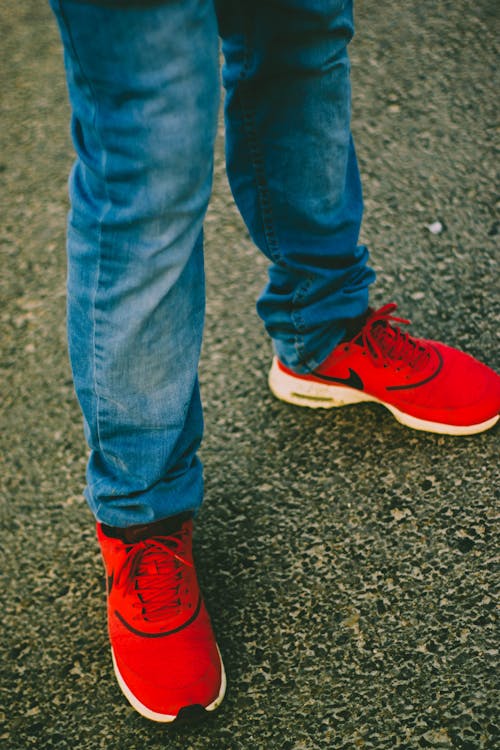 Free Person Wearing Red Nike Running Shoes Stock Photo