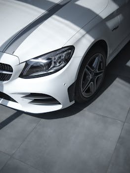 Close-up of a luxurious white car showcasing sleek design and modern elegance indoors.