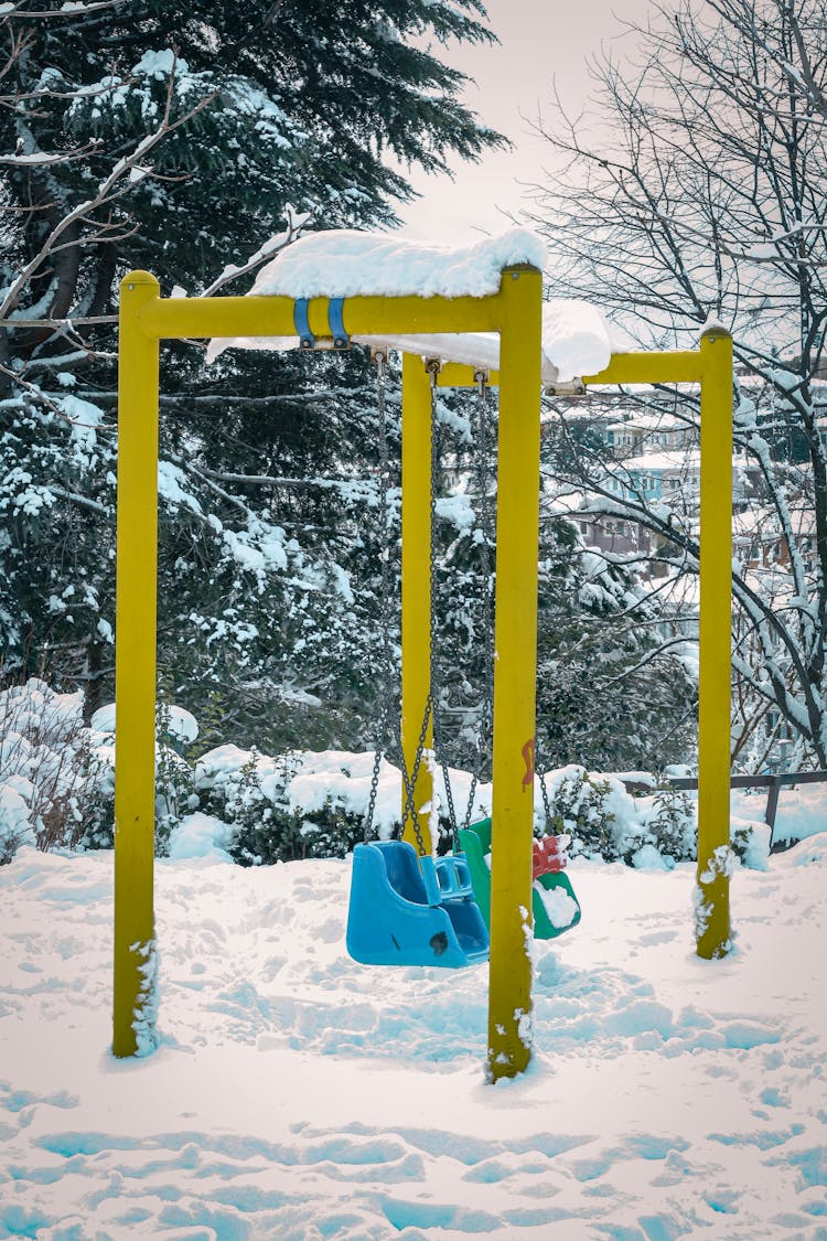 Two Swings At The Playground During Frosty Weather