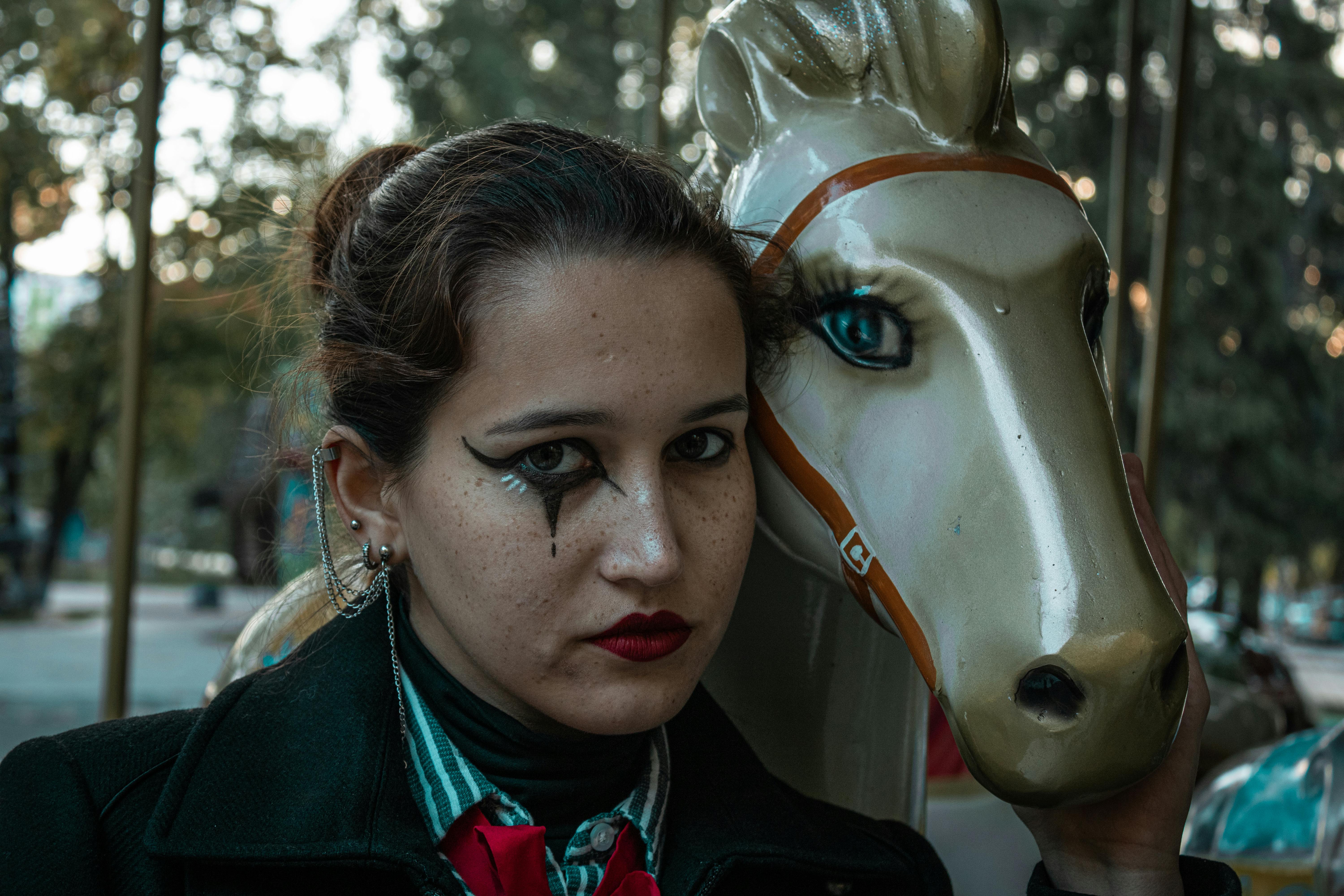 woman in black blazer with white horse head statue