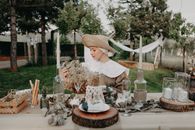 Woman in Old-fashioned Dress Sitting Behind Rustic Table Setting 