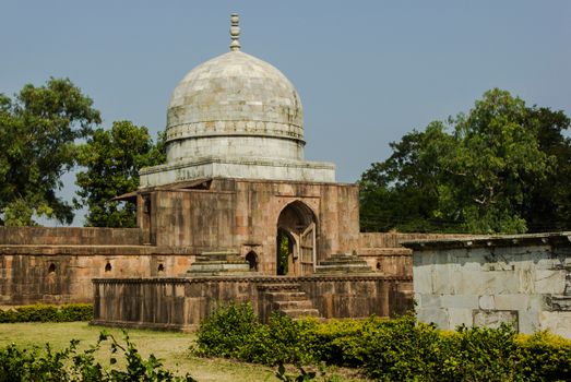 Hoshang Shah's Tomb, a historic mausoleum in Mandu, India, surrounded by lush greenery.