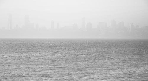 Free A foggy view of Mumbai's skyline seen across the Arabian Sea. Stock Photo