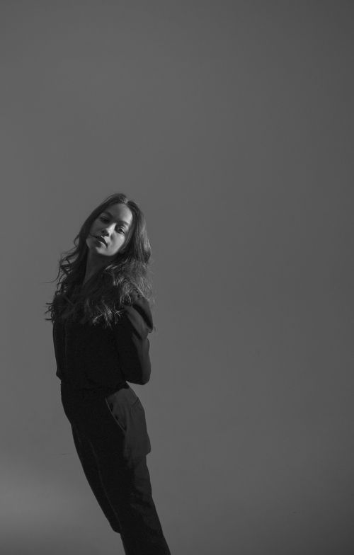 Free Monochrome portrait of a woman in a stylish pose against a plain background Stock Photo