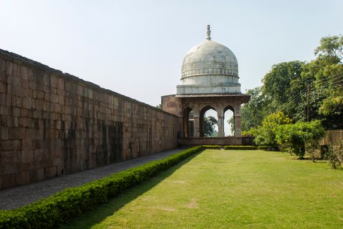 Free Ancient dome structure at Mandav, surrounded by lush gardens and greenery. Stock Photo
