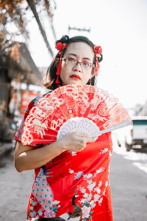 Woman Holding a Red Fan