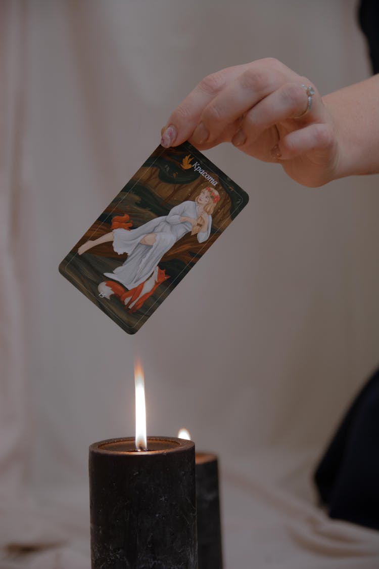 Holding Card Over Candle