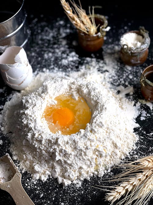 Egg on White Flour on the Table