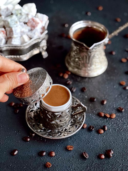 Free Close-up of traditional Turkish coffee and sweets in ornate silverware, capturing authentic culture. Stock Photo