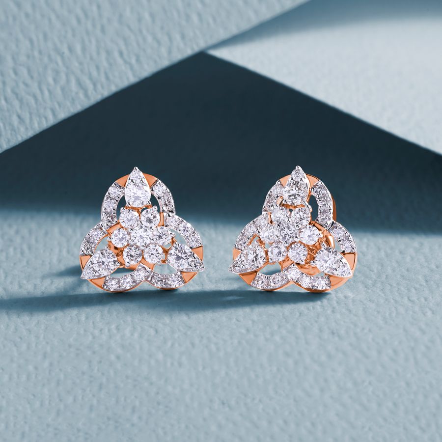 Diamond earrings with intricate design on a textured background