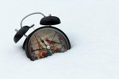 Free Black Alarm Clock on Snow Covered Ground Stock Photo