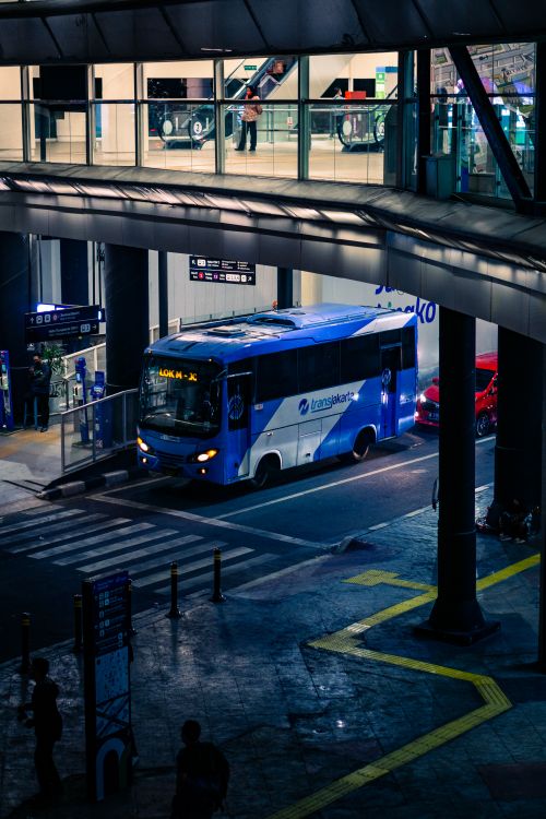 Free A vibrant city night scene capturing a blue bus at a bustling intersection in South Jakarta, Indonesia. Stock Photo