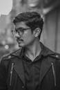 A Man in Black Jacket Wearing Eyeglasses