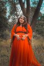 Woman in Re Dress Holding Her Belly