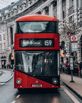 Classic red double-decker bus on Oxford Circus, showcasing London's iconic public transport.