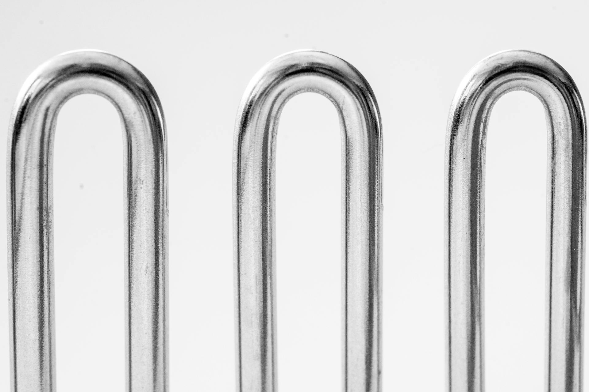 Detailed close-up of shiny metal coils featuring a minimalist and abstract aesthetic.