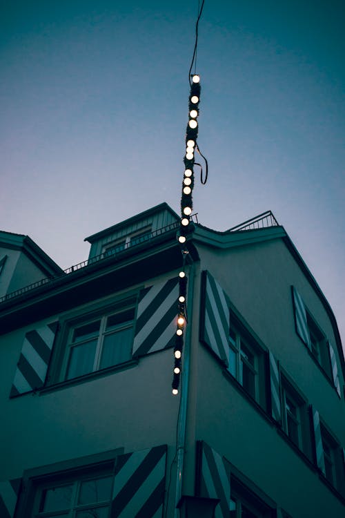 Brown Concrete Building With Red and White Light Post