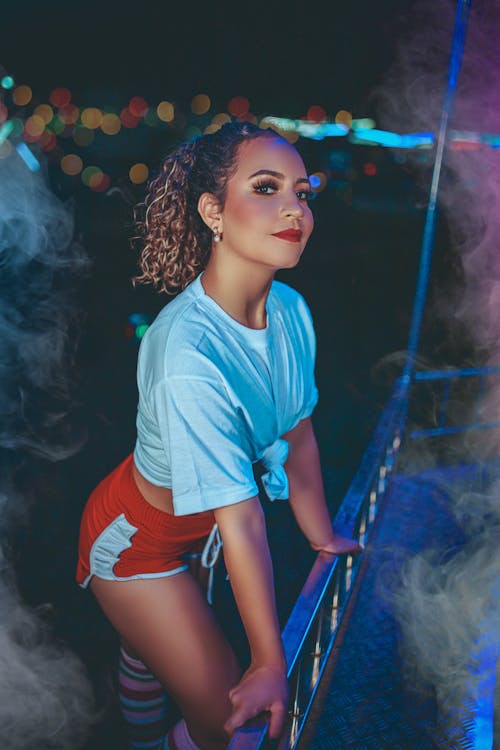 A Woman in White Crop Top and Red Shirts Posing