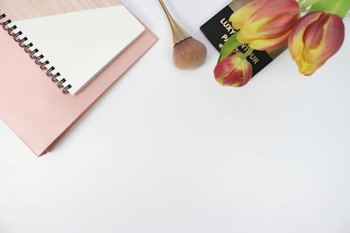 Makeup Brush Beside the Notebook