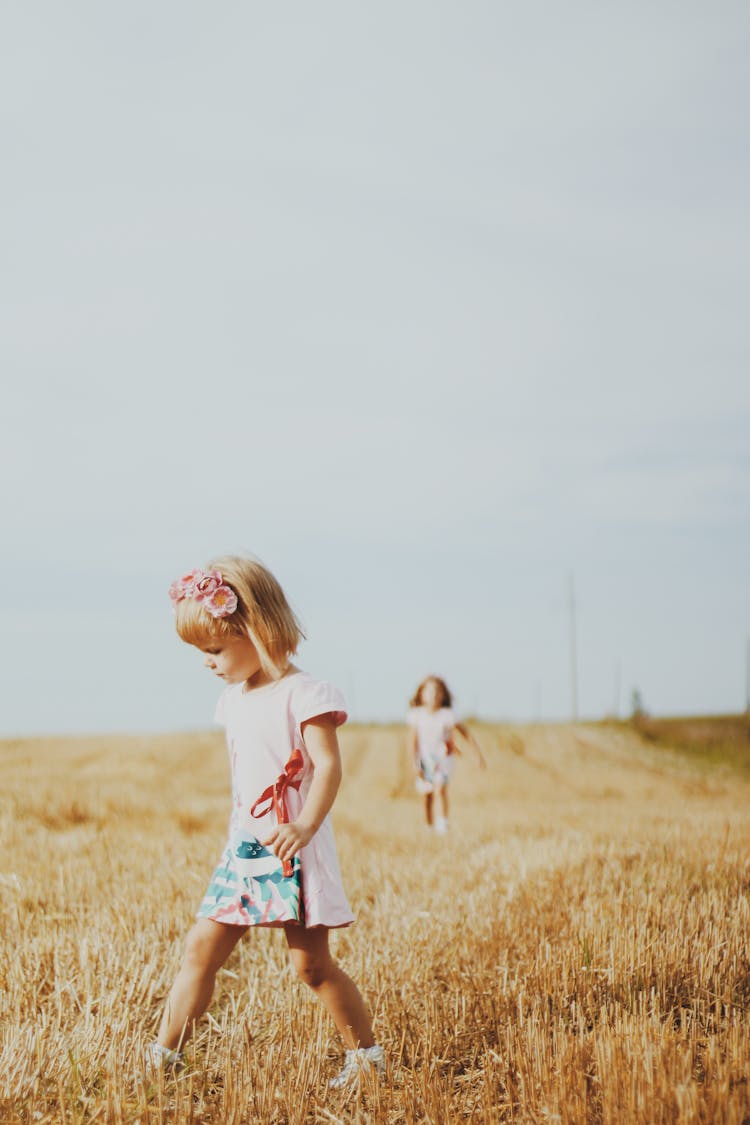 Girls Walking On Wheat Field