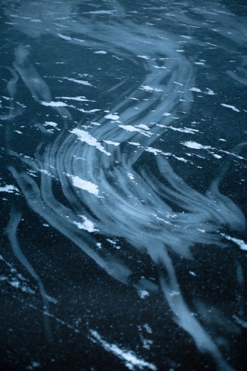 Free Intricate close-up of swirling ice patterns on a frozen surface, depicting the cold beauty of winter. Stock Photo