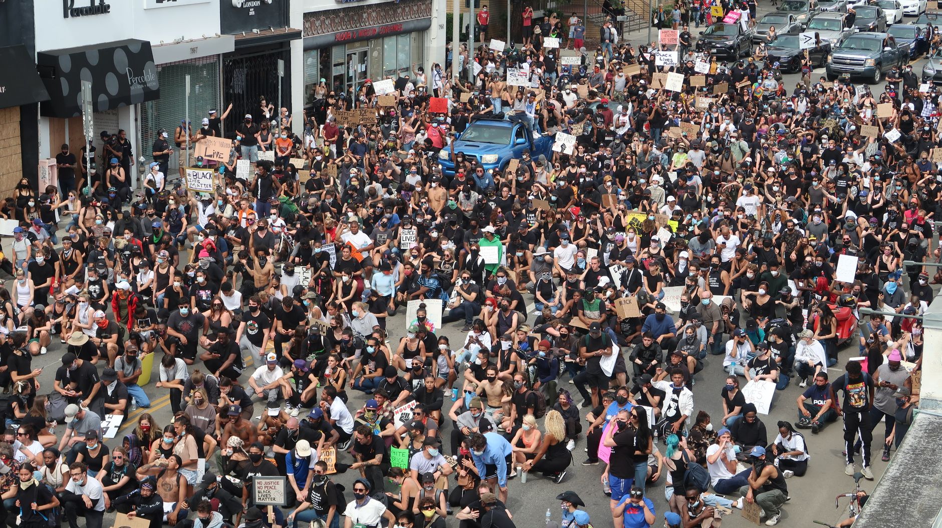 Aerial shot of a large protest gathering on a street in Los Angeles, CA.