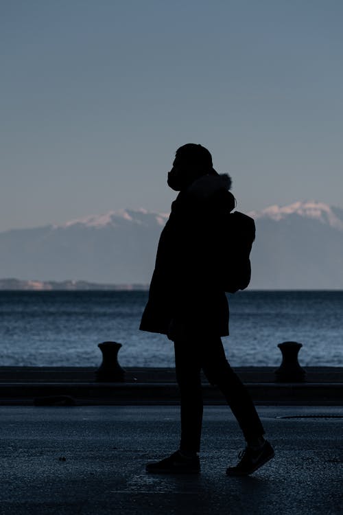 Man Silhouette Walking near Sea