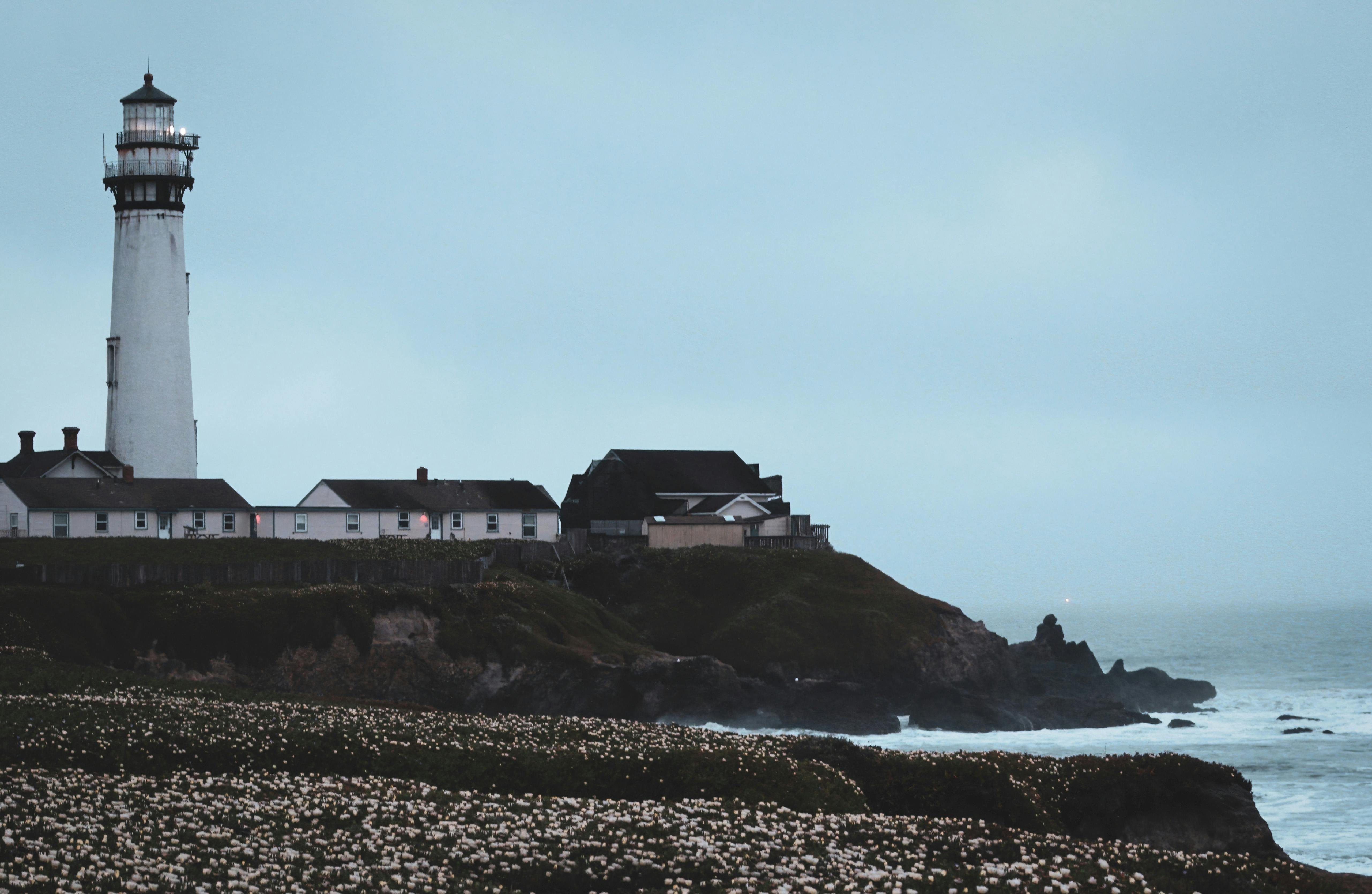 A scenic view of Pigeon Point Lighthouse and seashore in Pescadero, California.
