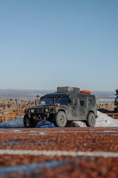 An adventure-ready Hummer parked in a snowy desert landscape, ideal for off-road explorations.
