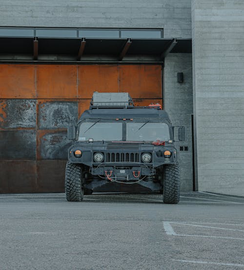 Humvee Parked Beside a Garage