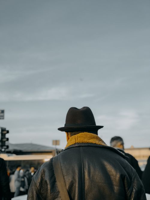 Free A stylish man in a hat and leather jacket captured from behind on an İstanbul street, offering ample copy space. Stock Photo