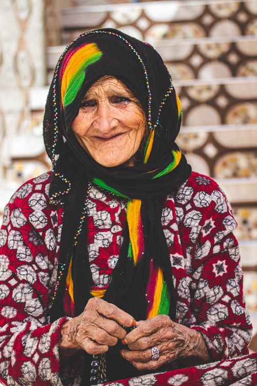 Free Smiling elderly woman wearing colorful headscarf and traditional attire in Morocco. Stock Photo