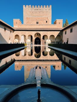 Captivating view of the Alhambra with perfect reflection in the courtyard pool.