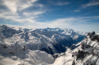 Snow Covered Mountains Under Cloudy Sky