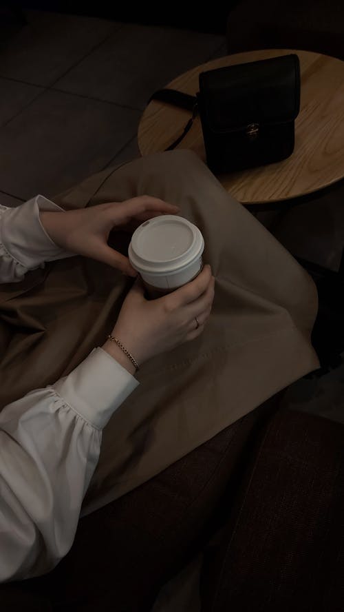 Person Holding a White Disposable Cup