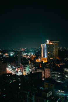 Illuminated cityscape of Kathmandu at night showcasing urban skyline and vibrant lights.