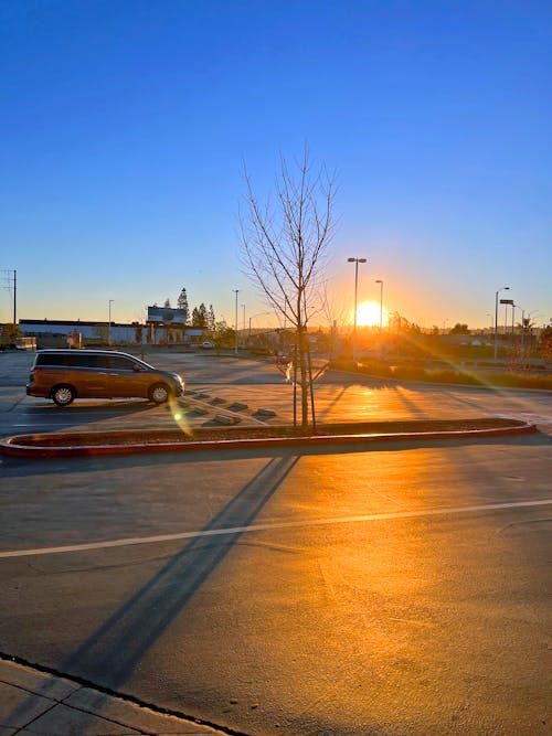 Free stock photo of blue skies, parking lot, sunset