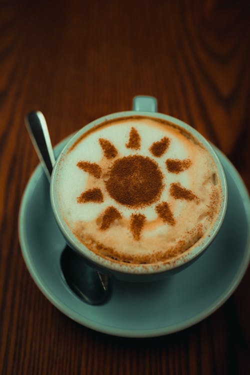 Free Cup and Saucer of Latte Art Sun Stock Photo