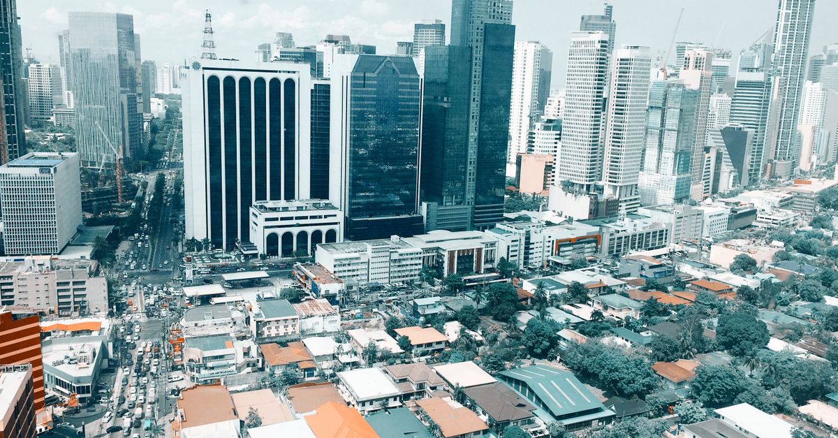 Vibrant aerial photo of the bustling Makati City skyline in the Philippines.