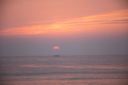 Free Tranquil sunset over the ocean in Yangyang, South Korea, with calm waters and vivid sky colors. Stock Photo