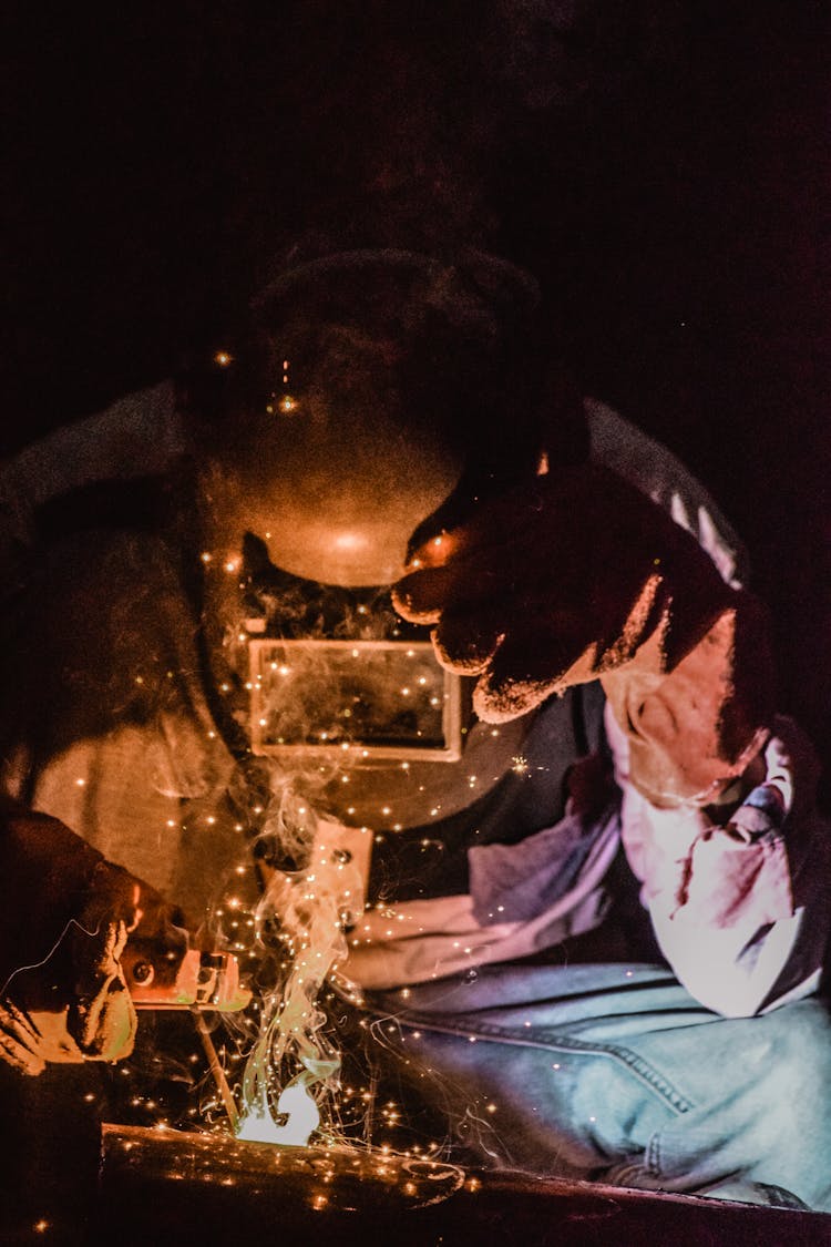 Photography Of A Person Wearing Welding Mask