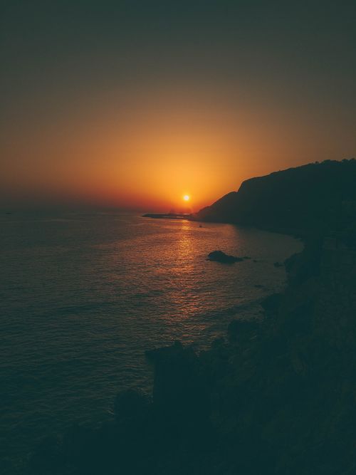 Free Captivating sunset view over the Mediterranean Sea with silhouetted cliffs in Alanya, Turkey. Stock Photo
