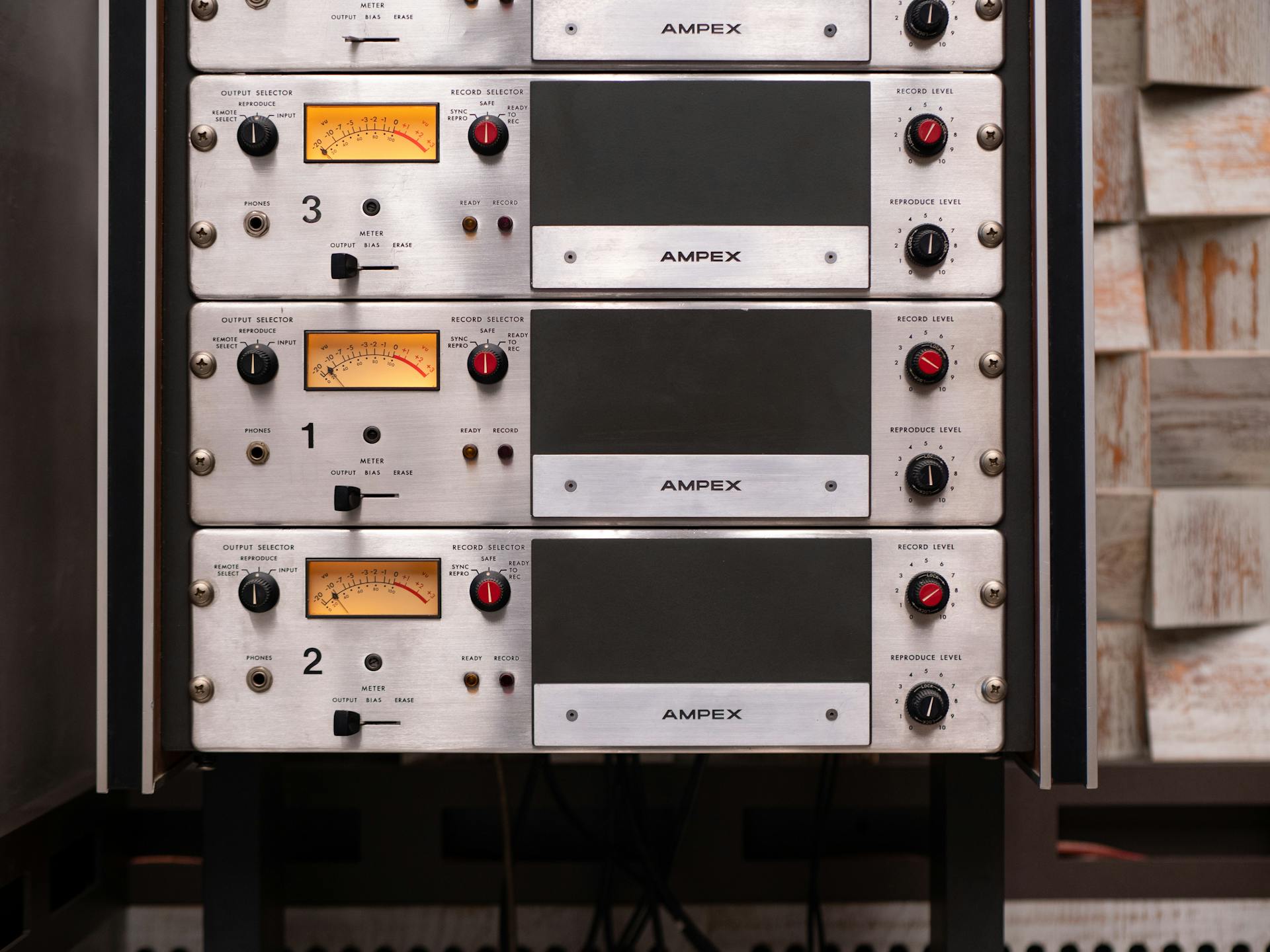 Close-up of vintage AMPEX audio recording equipment in a professional studio setting.